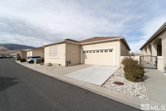 view of front of property with a mountain view and a garage