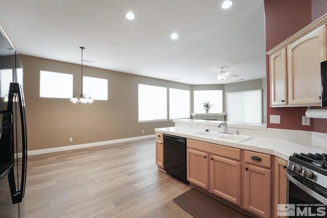 kitchen with tile countertops, sink, light wood-type flooring, light brown cabinetry, and stainless steel appliances