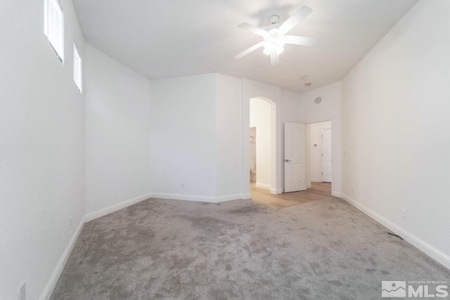 unfurnished bedroom with ceiling fan and light colored carpet