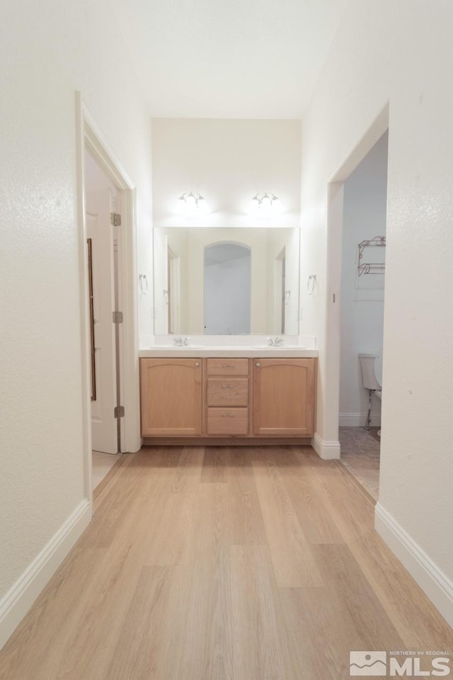 bathroom with vanity and hardwood / wood-style flooring