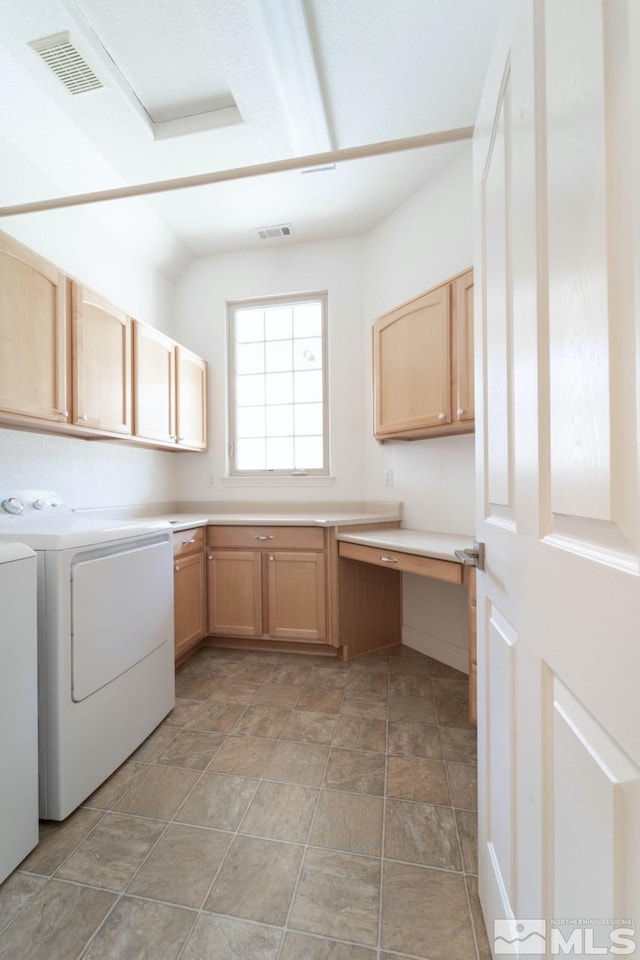 laundry room featuring cabinets and separate washer and dryer