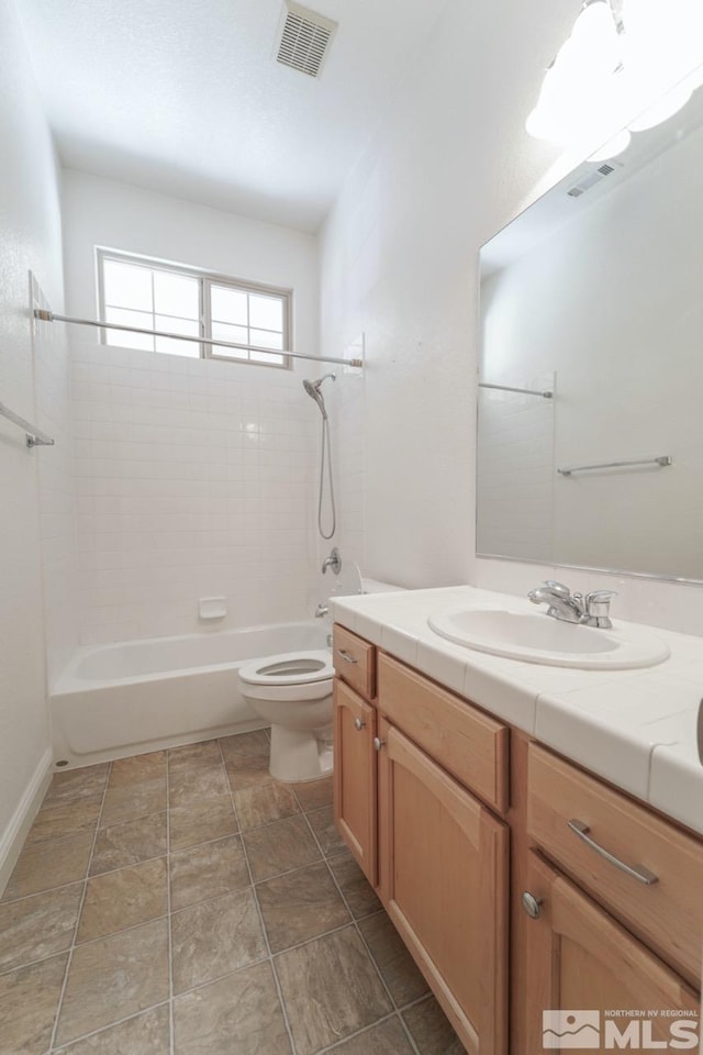 full bathroom featuring vanity, toilet, and tiled shower / bath