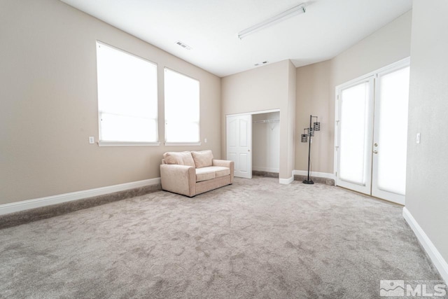 unfurnished room featuring a wealth of natural light and carpet floors