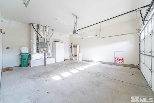 garage with a garage door opener and water heater