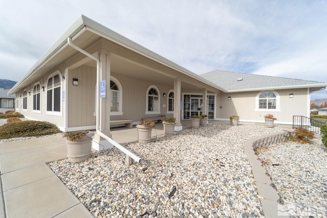 back of property with a porch