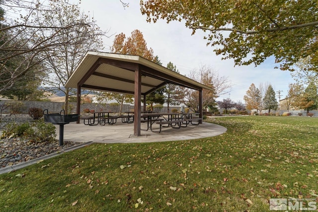 surrounding community featuring a lawn and a patio area