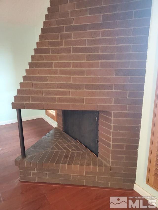 details featuring a fireplace and hardwood / wood-style flooring