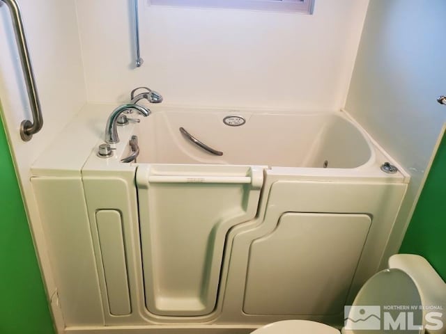 bathroom featuring a bathtub and toilet