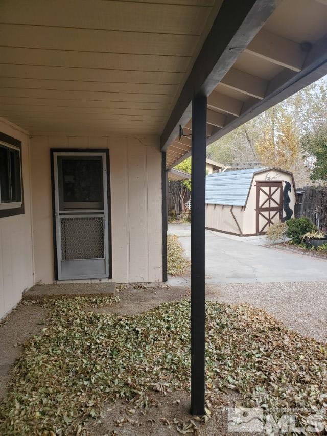 view of patio featuring a storage unit