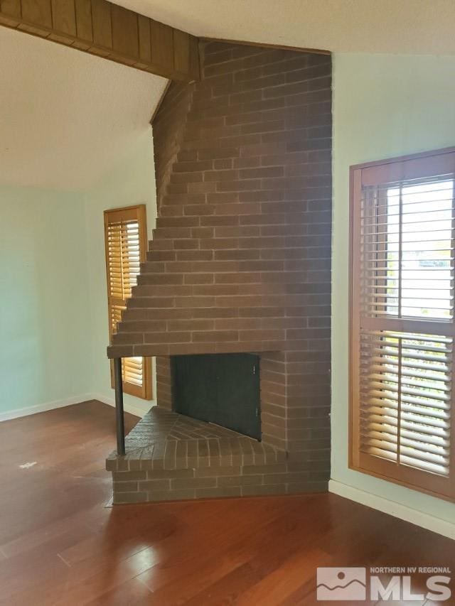 unfurnished living room with wood-type flooring and a fireplace