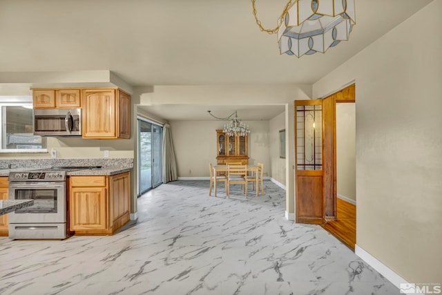 kitchen with a chandelier, light wood-type flooring, and appliances with stainless steel finishes