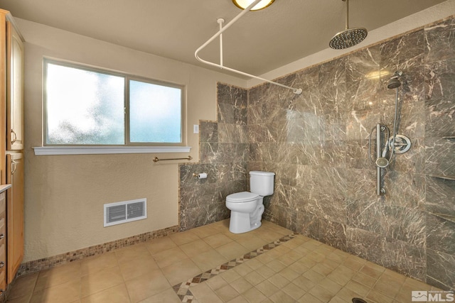 bathroom featuring tile patterned floors, a shower, and toilet