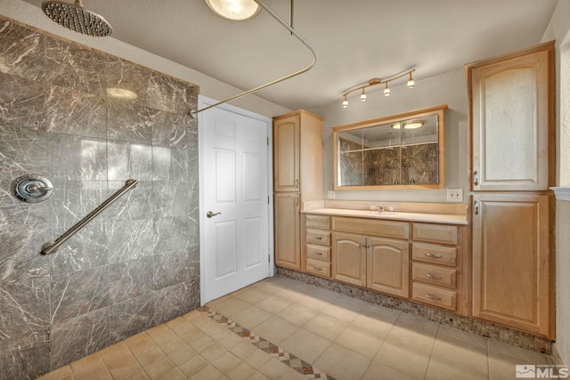 bathroom with tile patterned flooring, vanity, tile walls, and walk in shower