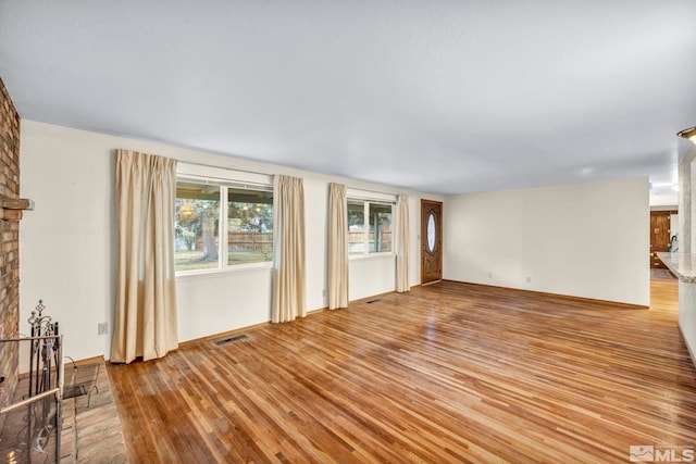 unfurnished living room with light hardwood / wood-style floors