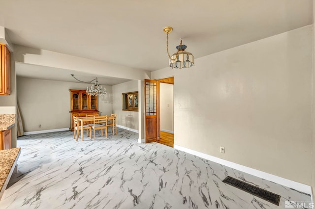 unfurnished dining area featuring a notable chandelier