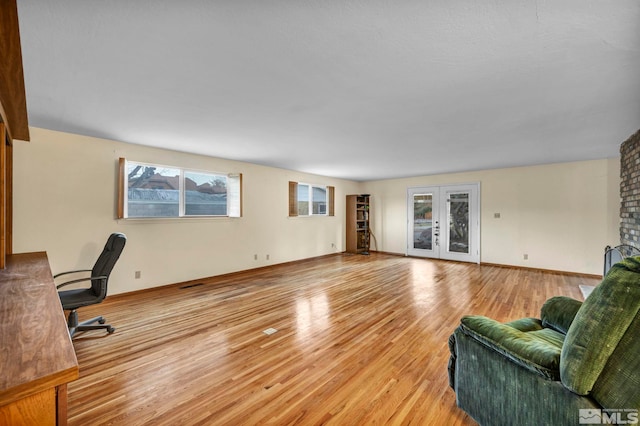 interior space with french doors and light hardwood / wood-style flooring