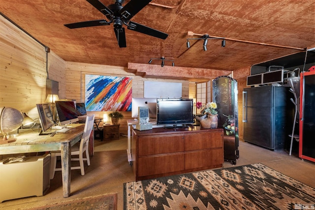 unfurnished office featuring ceiling fan and wood walls