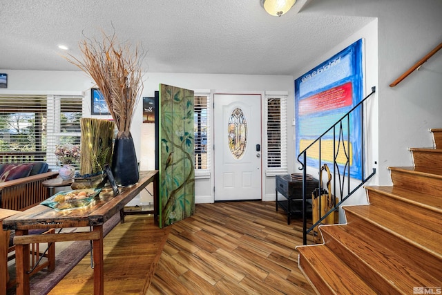 entrance foyer with a textured ceiling and hardwood / wood-style flooring