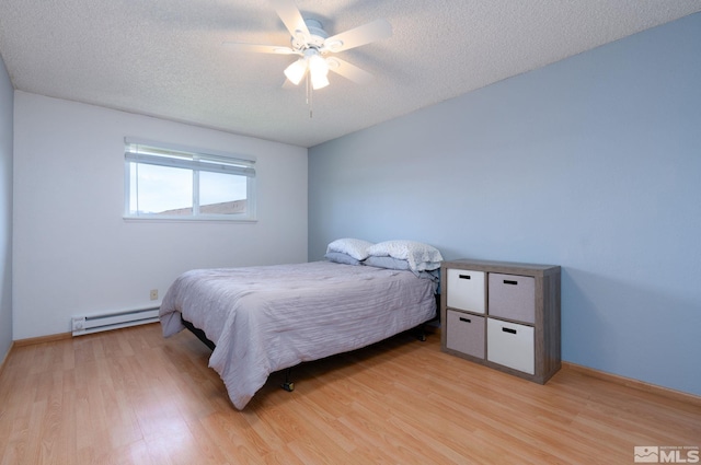 bedroom with baseboard heating, ceiling fan, a textured ceiling, and light wood-type flooring