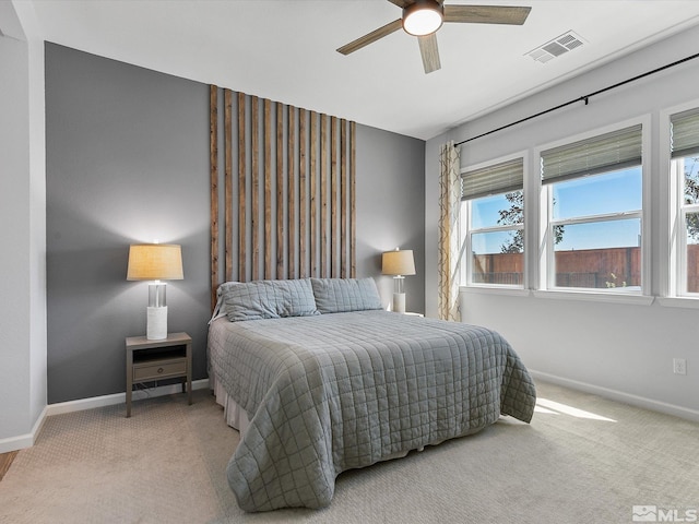 bedroom with ceiling fan and light colored carpet