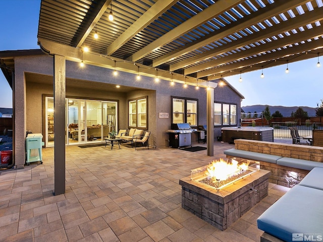 patio terrace at dusk with a pergola, a hot tub, grilling area, a mountain view, and an outdoor living space with a fire pit