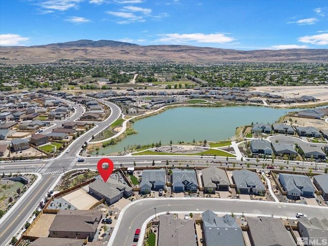 birds eye view of property with a water and mountain view