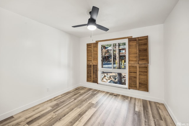 spare room featuring light wood-type flooring and ceiling fan