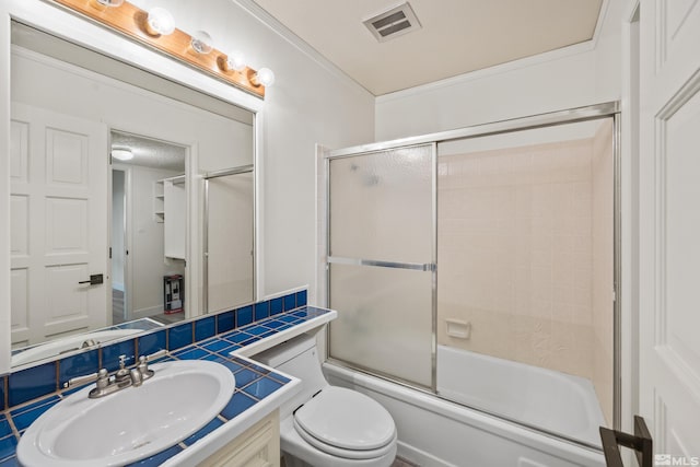 full bathroom featuring shower / bath combination with glass door, crown molding, vanity, and toilet