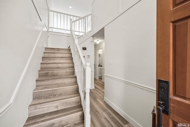 staircase with wood-type flooring