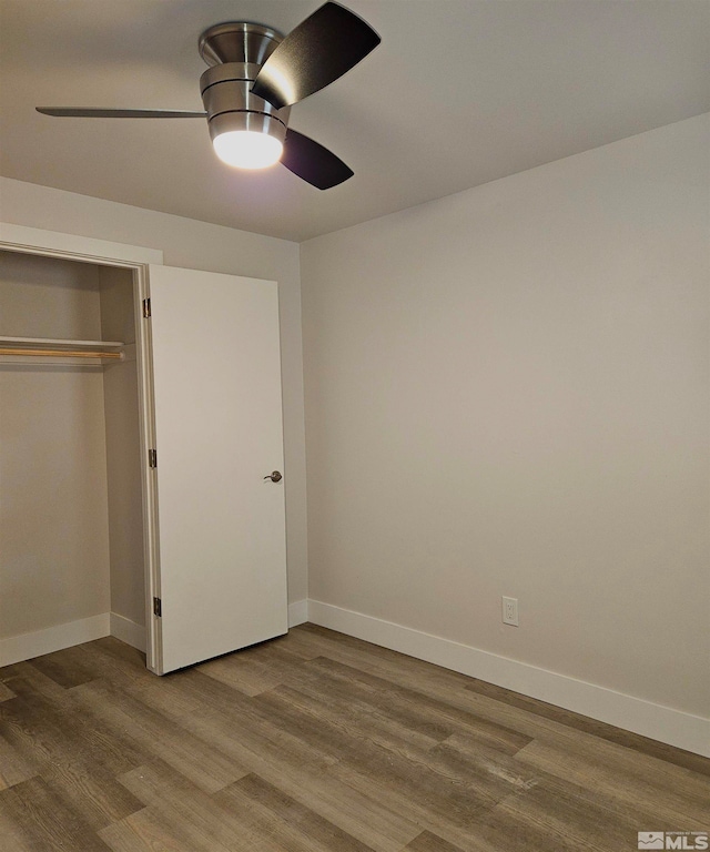 unfurnished bedroom with a closet, ceiling fan, and hardwood / wood-style floors