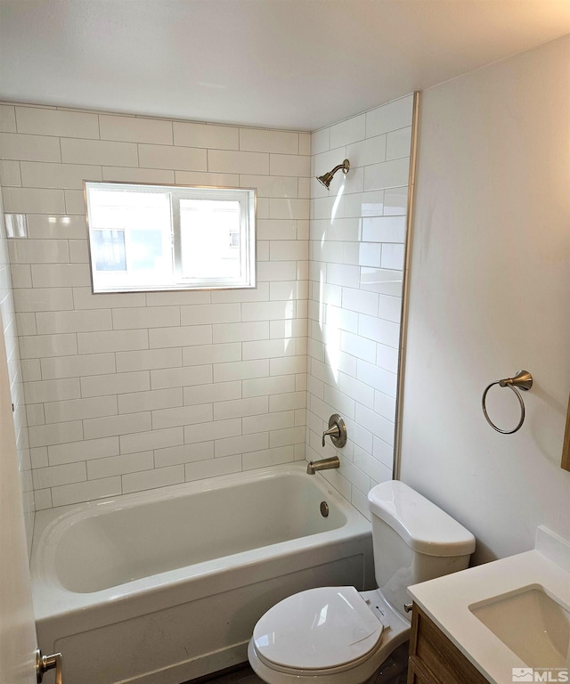 full bathroom featuring toilet, vanity, and tiled shower / bath combo