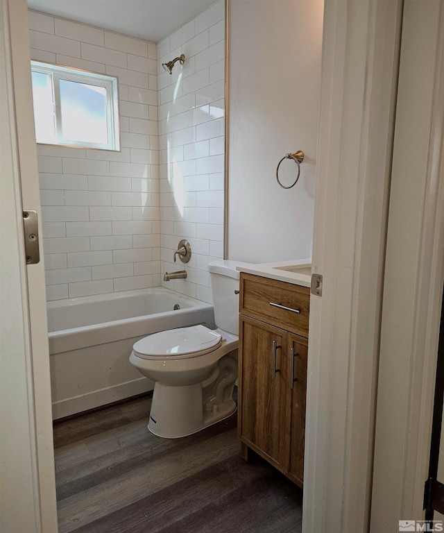 full bathroom with hardwood / wood-style floors, vanity, toilet, and tiled shower / bath combo