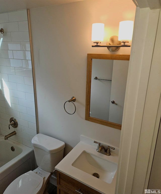 full bathroom featuring vanity, tiled shower / bath combo, and toilet