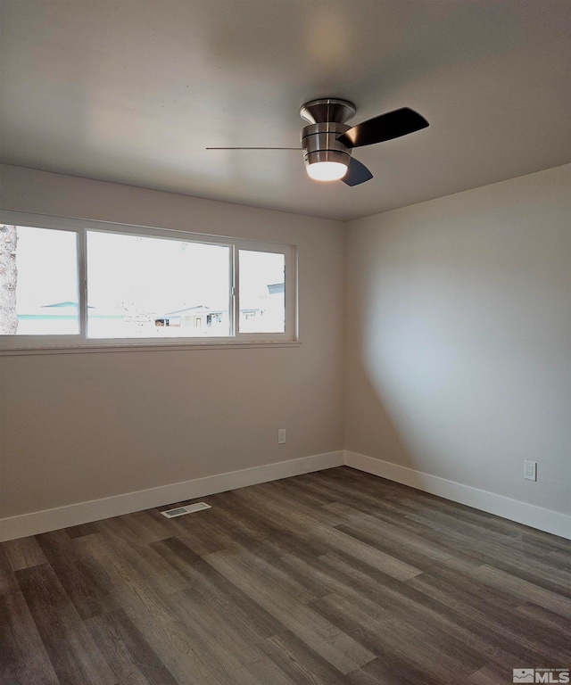 spare room featuring dark hardwood / wood-style floors and ceiling fan