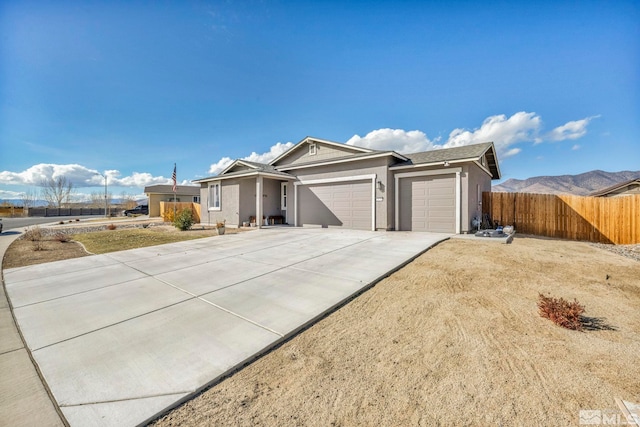 single story home featuring a mountain view and a garage