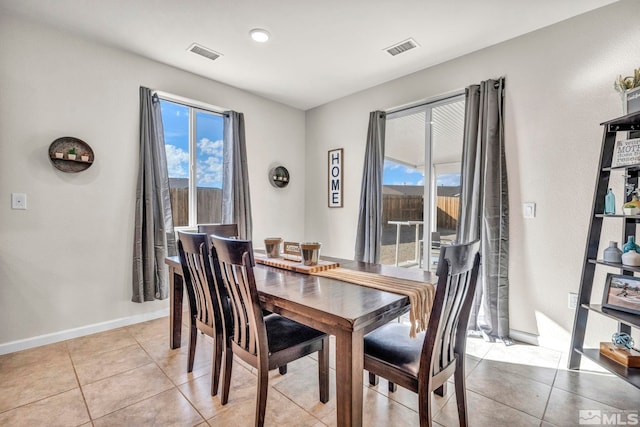 tiled dining room featuring a wealth of natural light