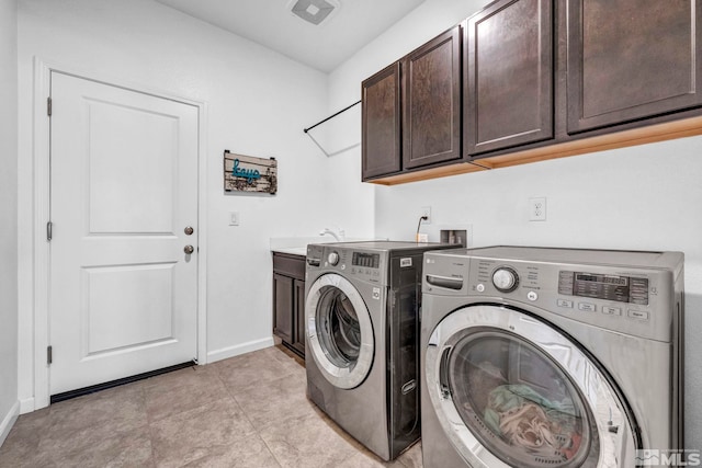 washroom with cabinets, light tile patterned floors, separate washer and dryer, and sink