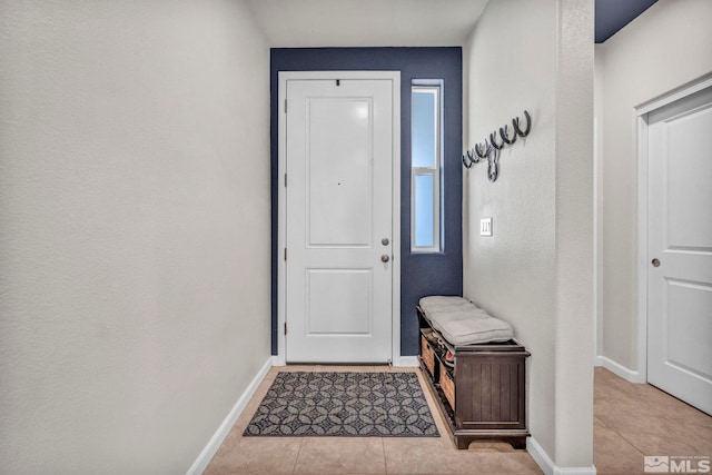 entryway with light tile patterned flooring