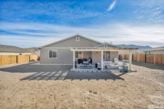 rear view of property with a pergola, a patio area, and a mountain view