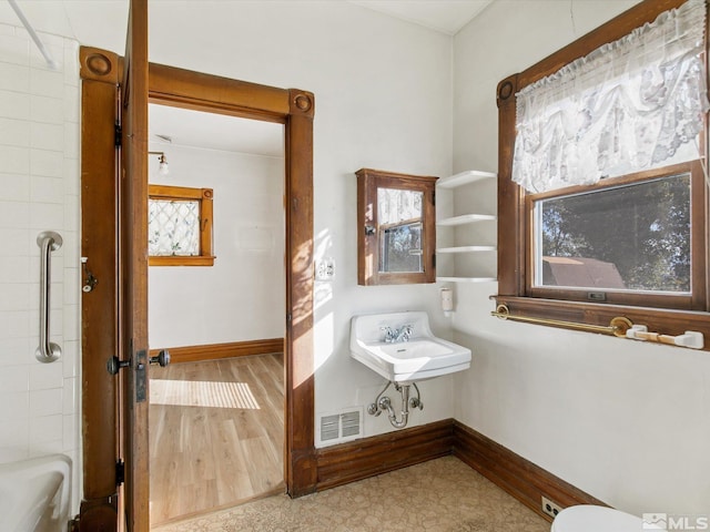 bathroom with shower with separate bathtub, hardwood / wood-style flooring, and sink