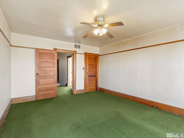 unfurnished bedroom with a closet, dark carpet, and ceiling fan