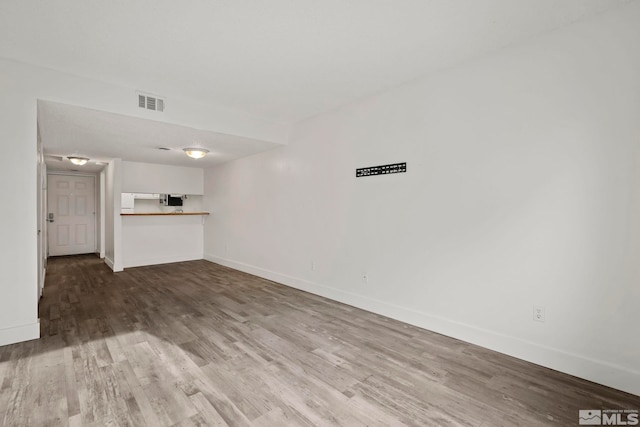 unfurnished living room featuring wood-type flooring