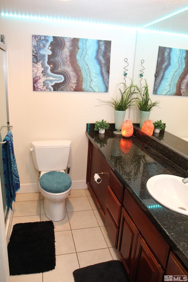 bathroom featuring tile patterned floors, vanity, and toilet