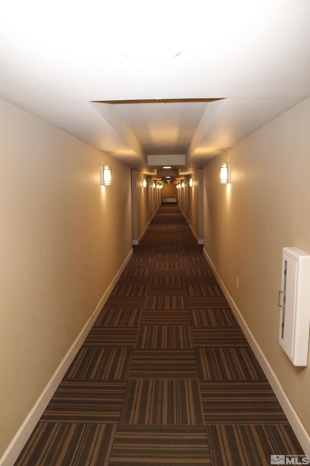 hallway with dark carpet