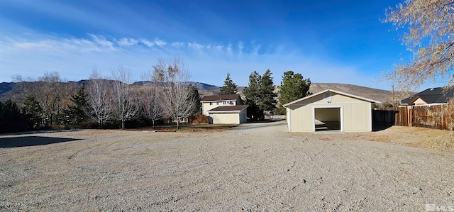 view of yard with a mountain view and an outdoor structure