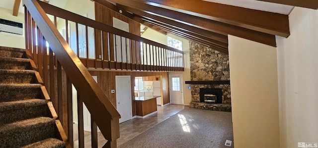 stairs featuring beam ceiling and high vaulted ceiling