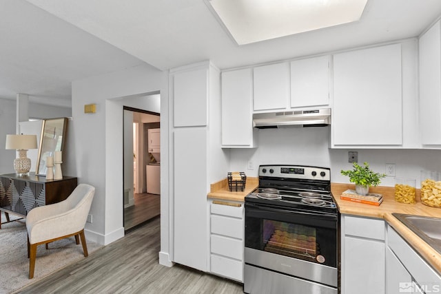 kitchen with white cabinetry, light wood-type flooring, and stainless steel electric range oven