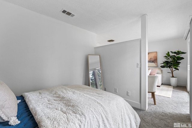 carpeted bedroom featuring a textured ceiling