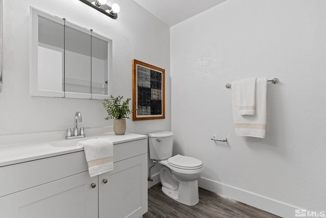 bathroom featuring hardwood / wood-style floors, vanity, and toilet