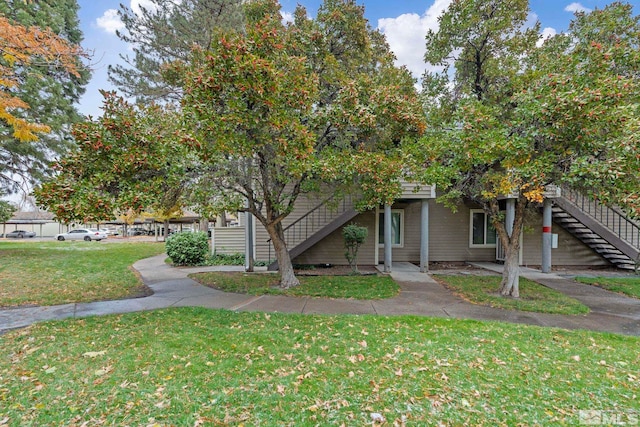 obstructed view of property featuring a front yard